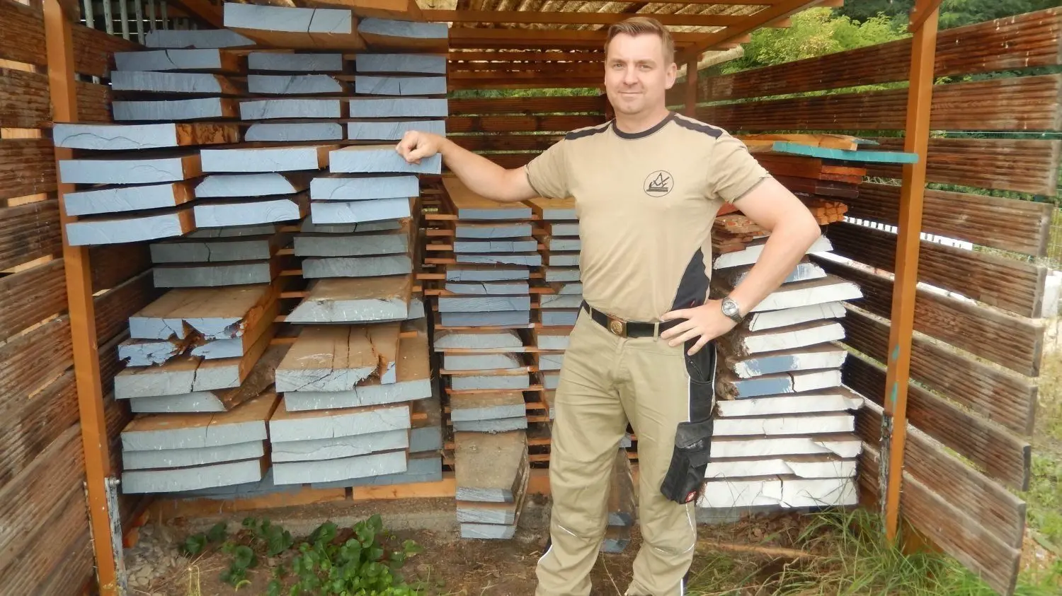 Thomas Kochan aus Forst vor einem Stapel Eichenbohlen aus dem eigenen Wald.