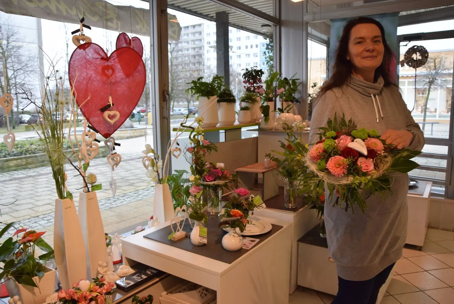 Die Floristin Susanne Janke aus Hoyerswerda präsentiert einen ihrer Blumensträuße mit weißem Porzellanherz.