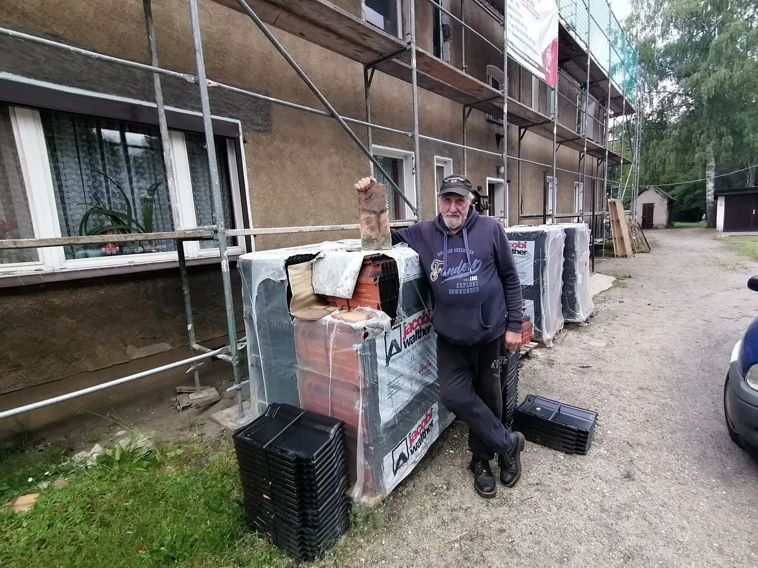 Bewohner Paul Urbanek glaubt nicht, dass großartig etwas passieren wird. Die Dachziegelpakete stehen seit Monaten vor dem Haus.