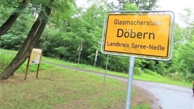 Das Ortseingangsschild Döbern am Radweg mitten im Wald.