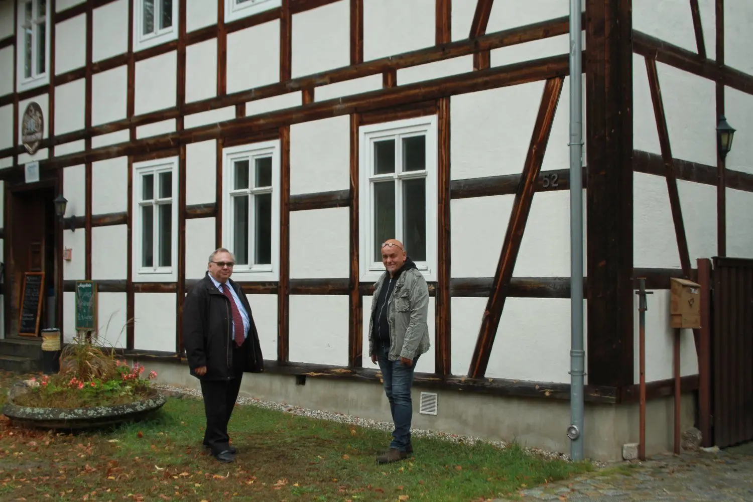 Schlepzigs Bürgermeister Werner Hämmerling (r.) und Norbert Schmidt als Vorsitzender des Fördervereins Aquamediale vor der alten Schlepziger Mühle. In einem Teil des Fachwerkgebäudes hat der Verein das Lausitzer Künstlerhaus eingerichtet.