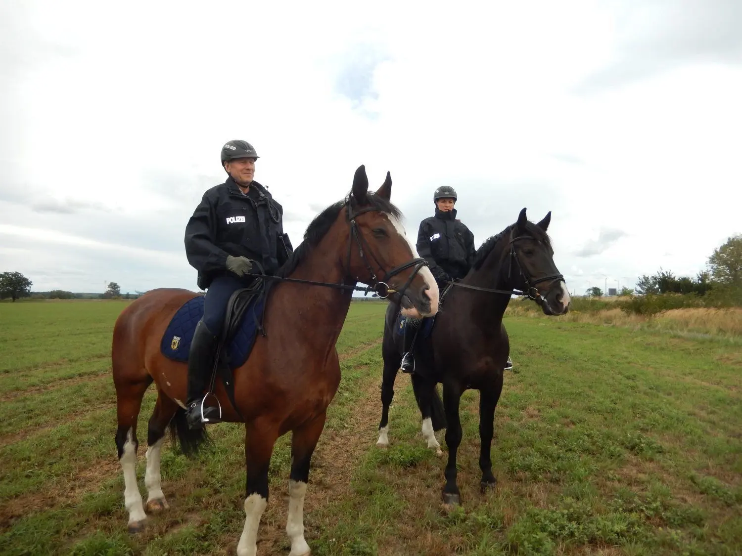 Die Bundespolizisten Gerald Ihlenfeld (l.) und  Maxi Berthold (r.) mit ihren Pferden Friedrich und Illano bei Sacro auf Streife.
