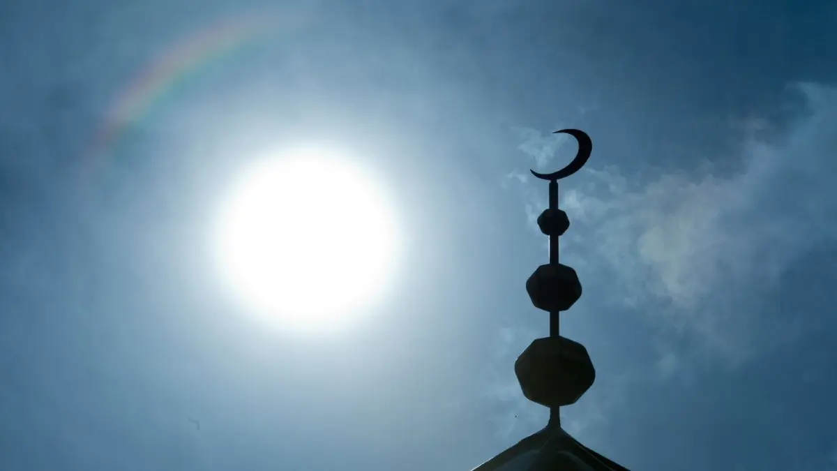 Eine Moschee in der Kreisstadt wollen die Senftenberger AfD-Abgeordeten verhindern. ⇥
ARCHIV - 19.09.2014, Frankfurt/Main: Der Halbmond auf dem Minarett der Abubakr Moschee hebt sich als Schattenriss vor der Sonne ab. Fasten im Ramadan, Beten fünfmal am Tag: Der Islam stößt auch bei manchen Bürgern in Rheinland-Pfalz auf Vorbehalte. Das Land hält unter anderem mit neuen Podiumsgesprächen dagegen. Foto: Boris Roessler/dpa +++ dpa-Bildfunk +++