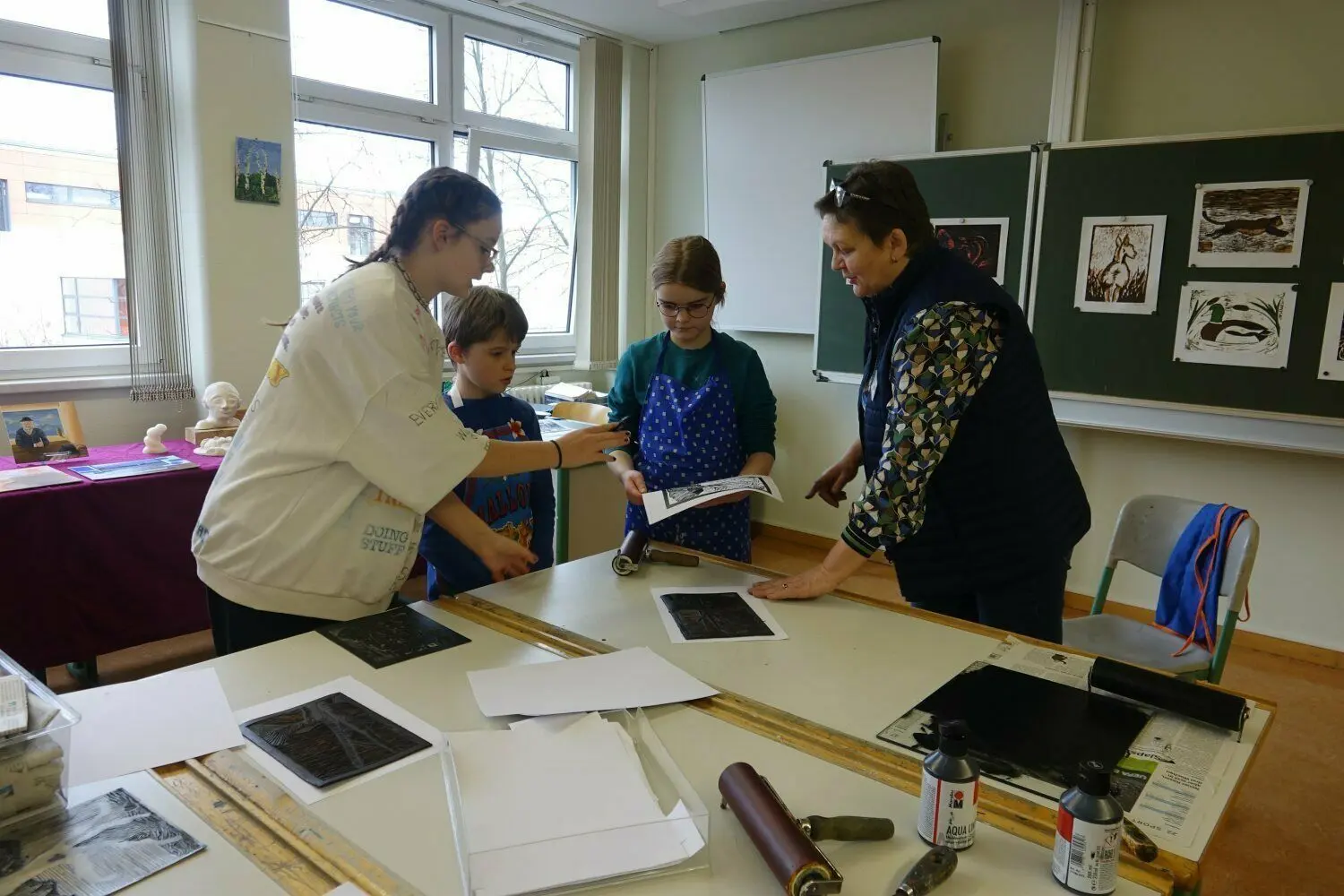 Grundschülerin Mathilde lässt sich beim Tag der offenen Tür am Landau-Gymnasium Weißwasser von Kunstlehrerin Bianka Benesch den Linol-Druck erklären.