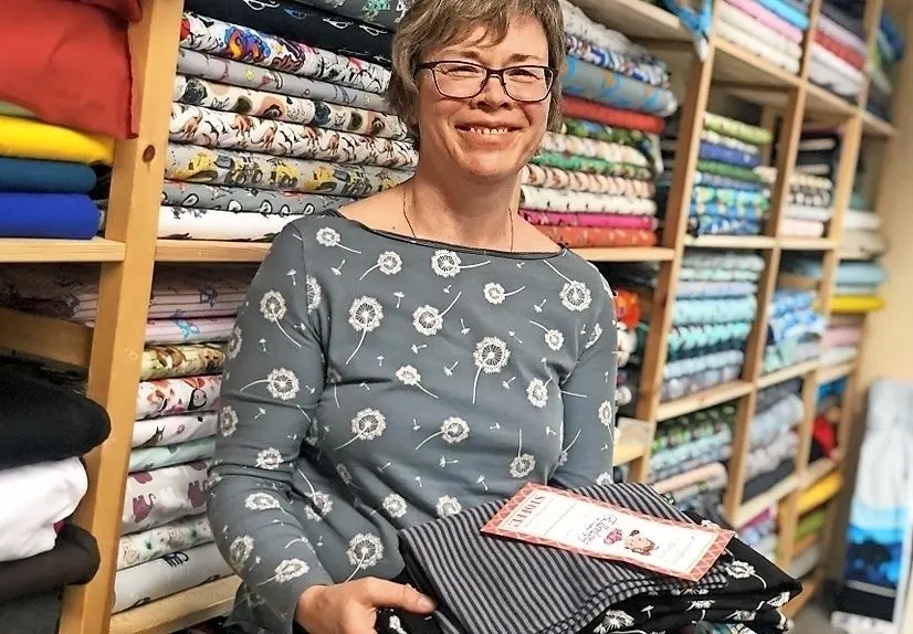 Sylke Kasper aus Lauta kommt mit selbstgenähtem Shirt ins Fachgeschäft und holt direkt Stoff-Nachschub für die nächsten Teile.