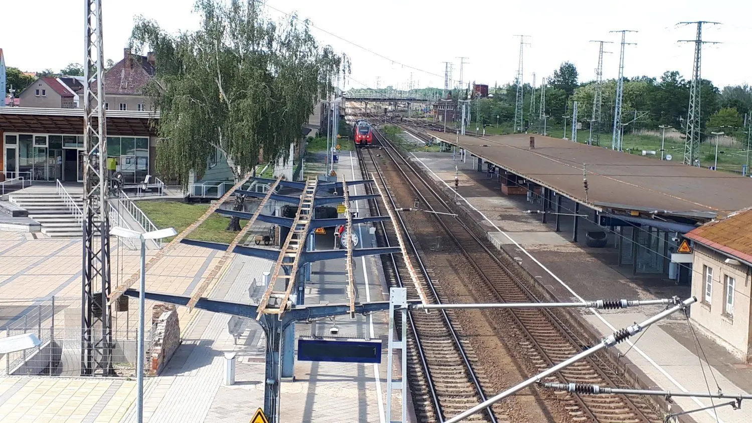 Ein Blick vom oberen auf den unteren Bahnhof. Die Schienenpaare von Nord nach Süd und Ost nach West zerschneiden die Stadt in vier Teile.⇥