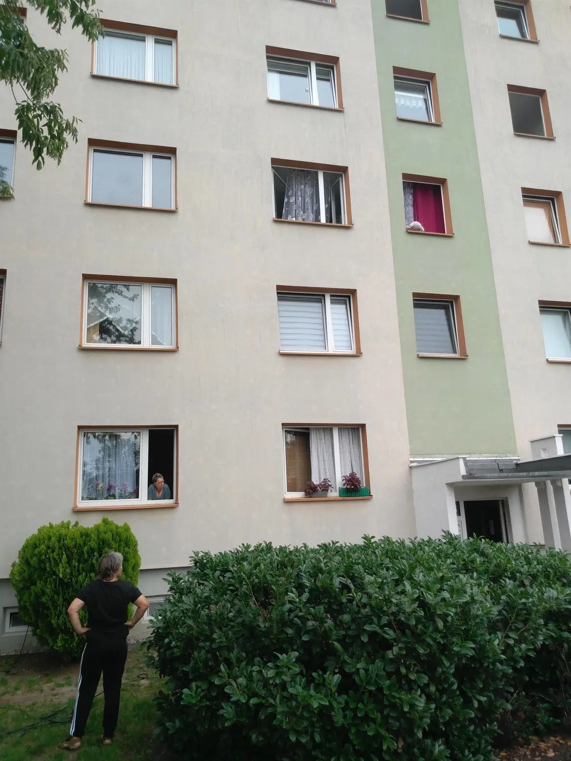 Einige Anwohner sind geblieben: Direkt neben dem Aufgang Nummer 16 schaut eine Frau am Freitag aus dem Fenster im Erdgeschoss und wertet mit einer anderen Mieterin die dramatischen Ereignisse der Nacht aus. Viele Fenster sind zum Lüften geöffnet, um der starken Geruchsbelästigung Herr zu werden. Im dritten Stockwerk liegt ein Plüschtier auf dem Fensterbrett. Von dort wurde ein Kind per Leiterwagen der Feuerwehr aus ihrem Zimmer gerettet.