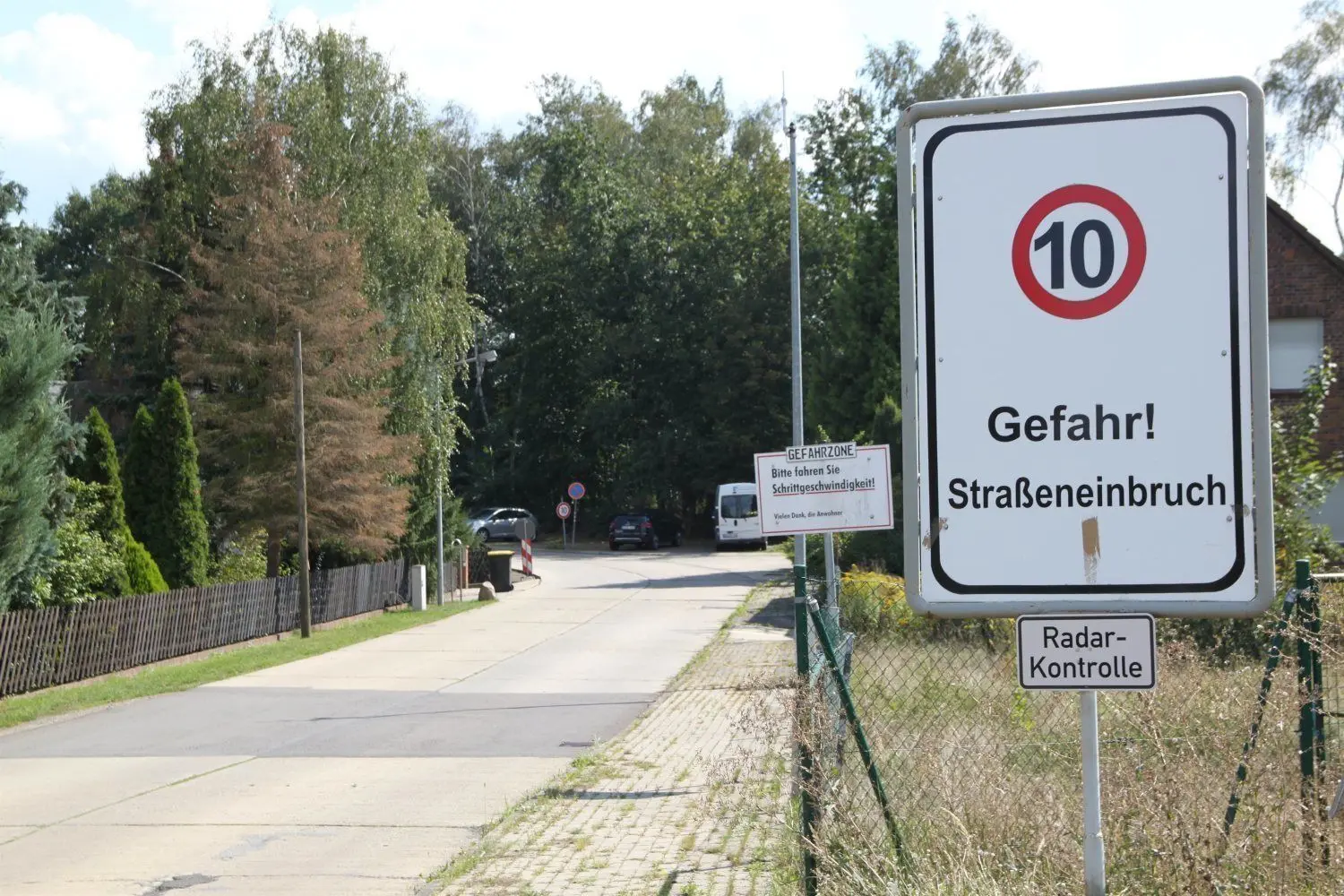 Auch das Wohn- und Gewerbegebiet in der benachbarten Külzstraße in Lauchhammer muss abgesiedelt werden. Auf der Straße darf praktisch nur Schrittgeschwindigkeit gefahren werden. Mehrere Schilder warnen.
