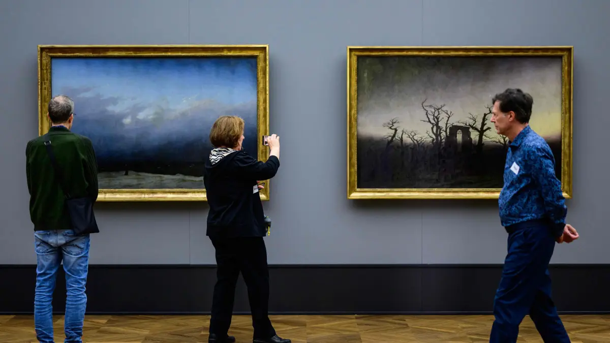 The paintings "Monk by the Sea" (L) and "Abbey among the Oaks" by German painter Caspar David Friedrich (1774-1840) are on display as part of the "Infinite Landscapes" exhibition at the Alte Nationalgalerie museum in Berlin on April 17, 2024. The exhibition, coinciding with the German romantic artist's 250th birth anniversary, will open from April 19 to August 4, 2024. (Photo by John MACDOUGALL / AFP)