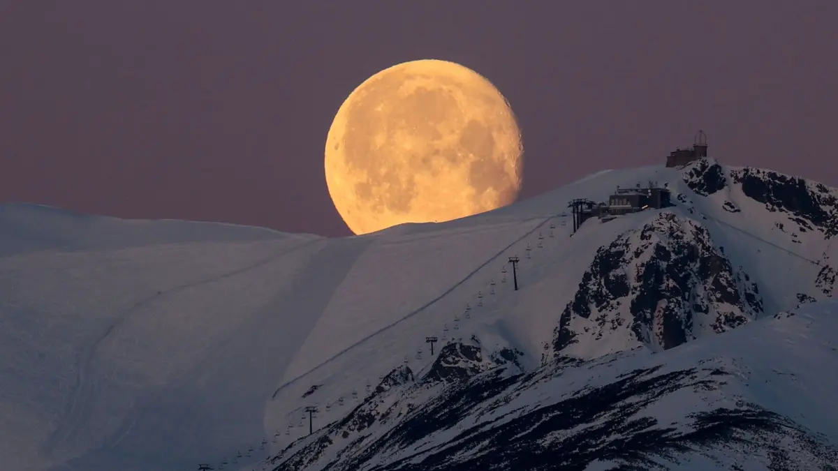 Mond über dem Tatra–Gebirge: 26.04.2024, Polen, Tatry: Der Monduntergang über dem Berg Kasprowy Wierch, in den polnischen Tatra-Bergen, von Polana Zgorzelisko aus gesehen. Der Mond um den April-Vollmond herum wird rosa genannt - der Name kommt von den Wildblumen, die im frühen Frühling blühen. In diesem Jahr fiel der rosa Vollmond auf den 24. April. Foto: Grzegorz Momot/PAP/dpa +++ dpa-Bildfunk +++