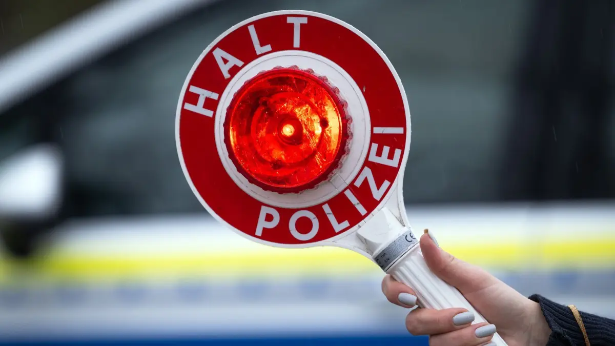 Verkehrskontrolle: ARCHIV - 22.03.2024, Brandenburg, Trebbin: Eine Polizistin hält während einer Verkehrskontrolle an der Berliner Straße eine Polizeikelle mit der Aufschrift „Halt Polizei“. (zu dpa: «Fahrer von Reisebus ist 27 Stunden ohne Pause unterwegs») Foto: Soeren Stache/dpa +++ dpa-Bildfunk +++