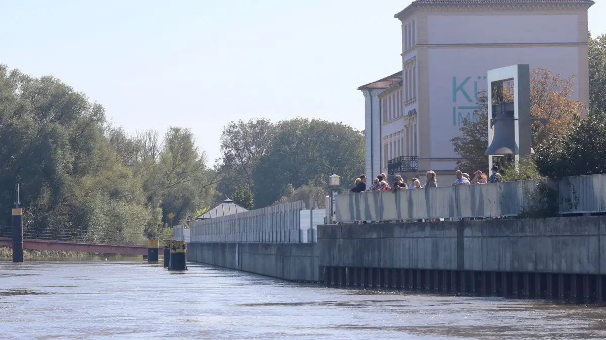 Spaziergänger am Holzmarkt in Frankfurt (Oder) blicken aufs Wasser, das ab Anfang nächster Woche weiter steigen soll.