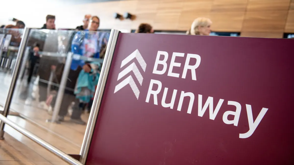 Beginn Herbstferien - Flughafen Berlin-Brandenburg: 18.10.2024, Brandenburg, Schönefeld: Ein Schild weist zum Start in die Berliner Herbstferien am Flughafen Berlin-Brandenburg (BER) auf den „BER Runway“ hin. Foto: Fabian Sommer/dpa +++ dpa-Bildfunk +++
