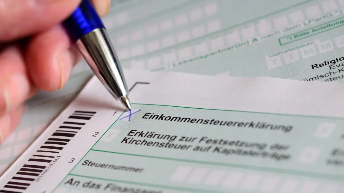 ARCHIV - 10.04.2017, Berlin: Eine Hand mit Kugelschreiber setzt ein Kreuz bei «Einkommensteuererklärung» auf dem offiziellen Formular des Finanzamts. (zu dpa: «Bahn, Ladekabel, Steuern - was sich im Dezember ändert») Foto: Hans-Jürgen Wiedl/dpa-Zentralbild/dpa +++ dpa-Bildfunk +++