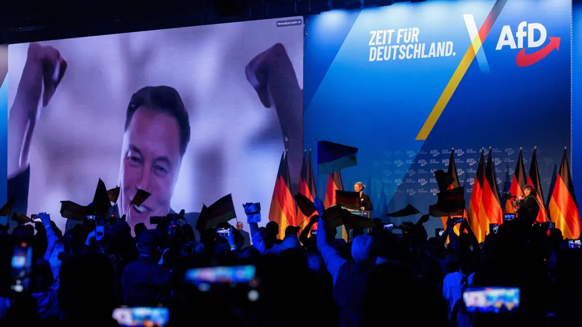 US tech billionaire and businessman Elon Musk (L) is seen on a large screen as Alice Weidel, co-leader of Germany's far-right Alternative for Germany (AfD) party, addresses an election campaign rally in Halle, eastern Germany on January 25, 2025. (Photo by AFP)