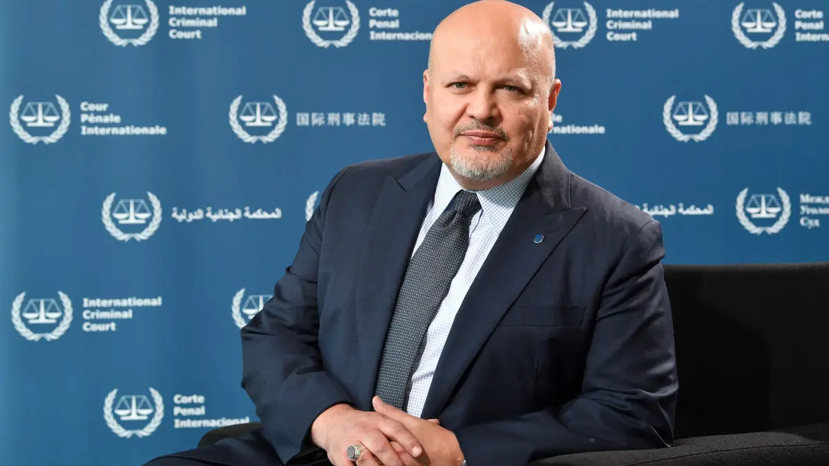 (FILES) Chief prosecutor of the International Criminal Court (ICC) Karim Khan poses for a picture at the ICC headquarters in The Hague on May 27, 2022. International Criminal Court chief prosecutor Karim Khan, being probed for alleged misconduct, is stepping down temporarily, his office announced on May 16, 2025. Khan "communicated his decision to take leave until the end" of the UN internal investigation, and his deputy prosecutors will run the office in his absence, it said in a statement. (Photo by JOHN THYS / AFP)