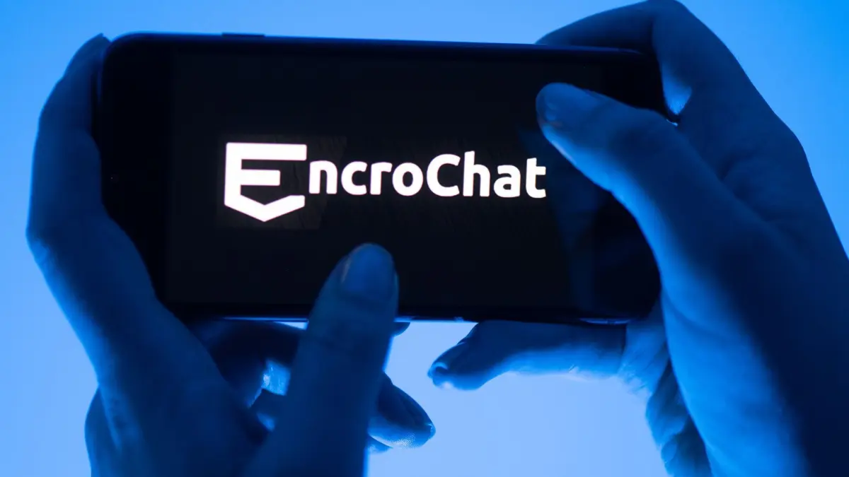 Encrochat: ARCHIV - 12.05.2022, Sachsen, Dresden: ILLUSTRATION - Eine Frau hält ein Smartphone mit dem Logo des Krypto-Messengerdienstes Encrochat (gestellte Szene). (zu dpa: «Staatsanwaltschaft: Mehr als 600 Encrochat-Verfahren») Foto: Sebastian Kahnert/dpa +++ dpa-Bildfunk +++