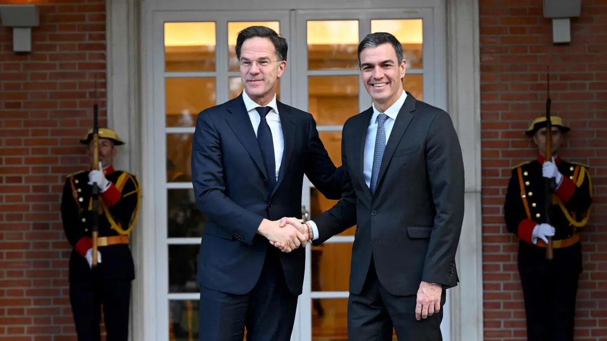 (FILES) Spain's Prime Minister Pedro Sanchez welcomes NATO Secretary General Mark Rutte (L) during his visit at La Moncloa Palace in Madrid on January 27, 2025. Spain has reached a deal with NATO exempting it from the alliance's five-percent target for defence spending demanded by US President Donald Trump, Prime Minister Pedro Sanchez said. (Photo by JAVIER SORIANO / AFP)