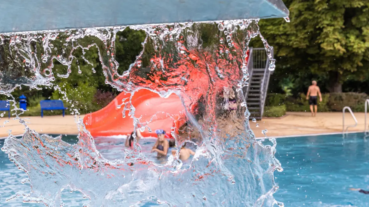 Freibad Forst: Wasser rinnt aus einem Sprudler im Forster Freibad und gibt den Blick auf eine Rutsche frei. Seit dem 24. Juli sind in Brandenburg Sommerferien.