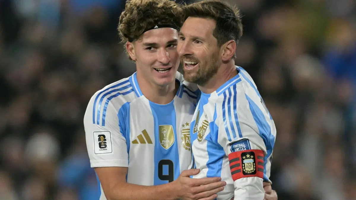 Argentina's forward #10 Lionel Messi celebrates after scoring his second goal with forward #09 Julian Alvarez during the 2026 FIFA World Cup South American qualifiers football match between Argentina and Venezuela at the Mas Monumental stadium in Buenos Aires on September 4, 2025. (Photo by JUAN MABROMATA / AFP)