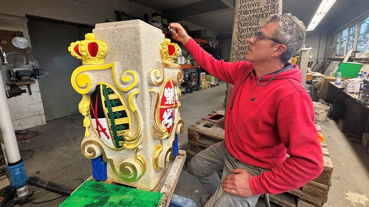 In Teilen vergoldet Guido Heinrich das Wappenstück der Distanzsäule Elsterwerda.