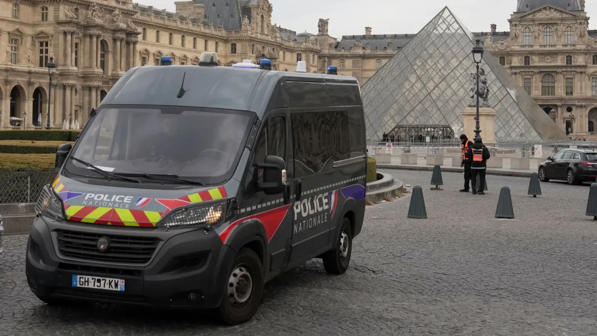 ARCHIV - 19.10.2025, Frankreich, Paris: Ein Polizeiauto patrouilliert im Hof des nach einem Raubüberfall geschlossenen Louvre-Museums. (zu dpa: «Weitere Festnahmen nach Louvre-Kunstraub») Foto: Thibault Camus/AP/dpa +++ dpa-Bildfunk +++