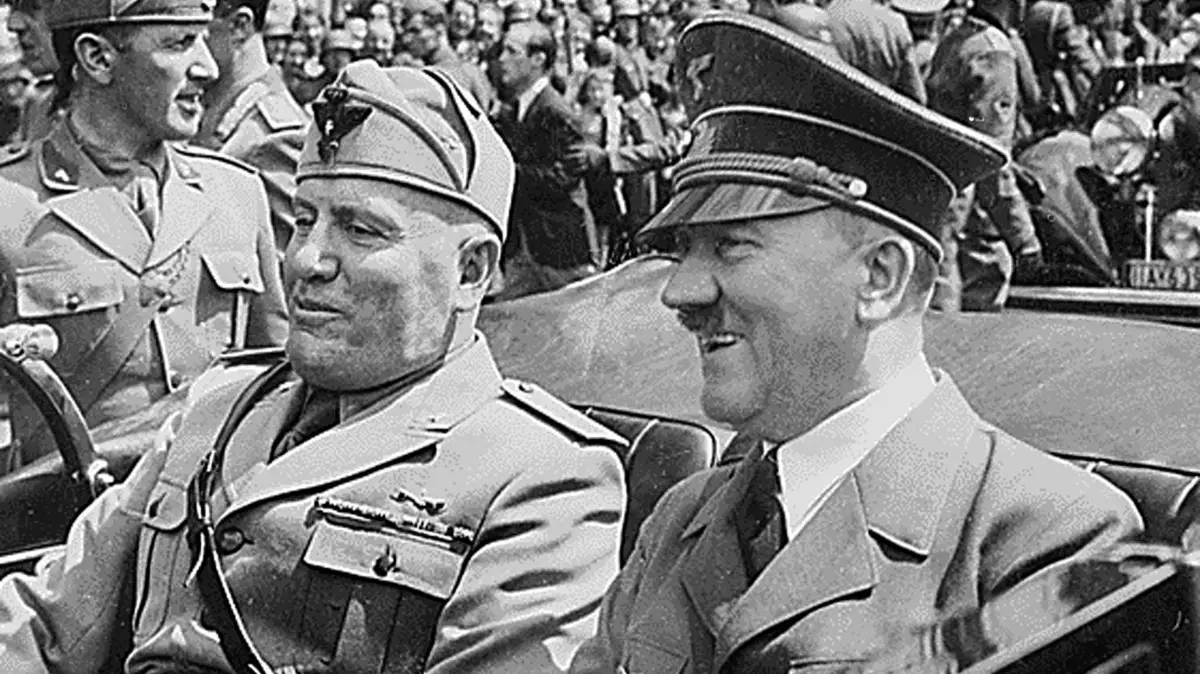 (FILES) This file handout photo from The National Archives taken in June 1940 in Munich, Germany shows Adolf Hitler (R) riding in a car with Italian Fascist dictator Benito Mussolini (L) during World War II. Adolf Hitler most likely suffered from the genetic condition Kallmann Syndrome that can manifest itself in undescended testicles and a micropenis, researchers and documentary makers said on November 13, 2025, following DNA testing of the Nazi dictator's blood. The new research also quashes the suggestion that Hitler had Jewish ancestry. (Photo by Handout / THE NATIONAL ARCHIVES / AFP) / - NO Editorial use - NO Marketing campaign / -----EDITORS NOTE --- RESTRICTED TO EDITORIAL USE - MANDATORY CREDIT "AFP PHOTO / The National Archives" - NO MARKETING - NO ADVERTISING CAMPAIGNS - DISTRIBUTED AS A SERVICE TO CLIENTS