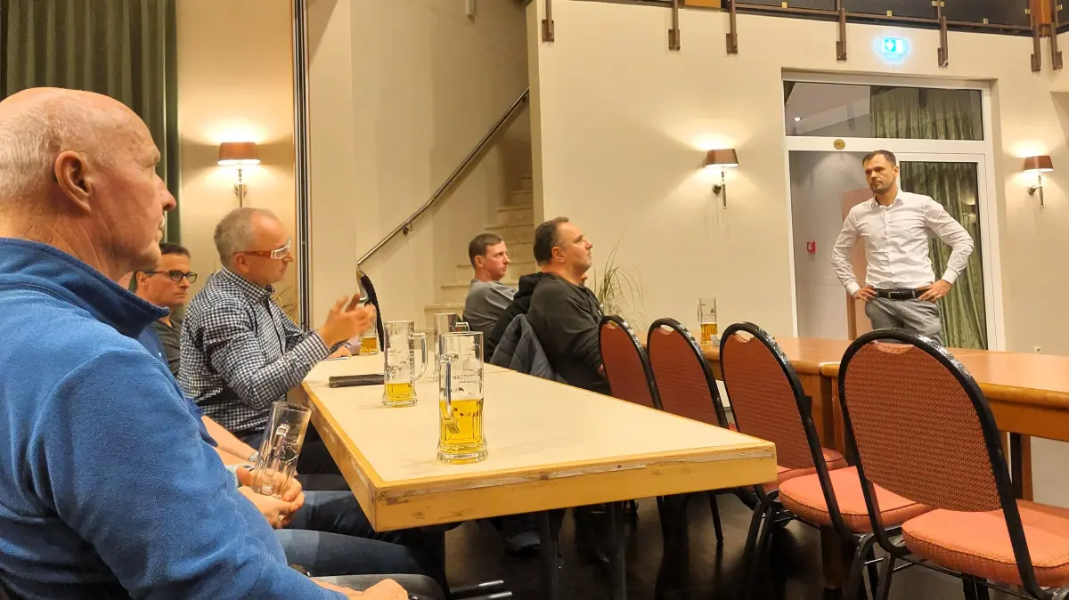 Bürger aus Tauer im Gespräch mit Leag-Mitarbeiter Steffen Walter (rechts): Die Gutachten zu den Schadensanträgen sorgen für Skepsis im Ort, denn an der Art, wie die Schriftsätze erstellt wurden, gibt es Kritik.