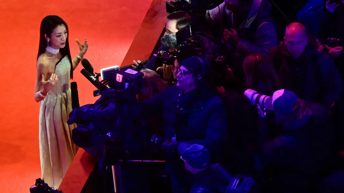 776458798: Malaysian actress Michelle Yeoh speaks to journalists as she arrives on the red carpet for the premiere of the film "No Good Men" presented in the Berlinale Special Gala section and opening the 76th Berlinale, Europe's first major film festival of the year, in Berlin on February 12, 2026. (Photo by John MACDOUGALL / AFP)