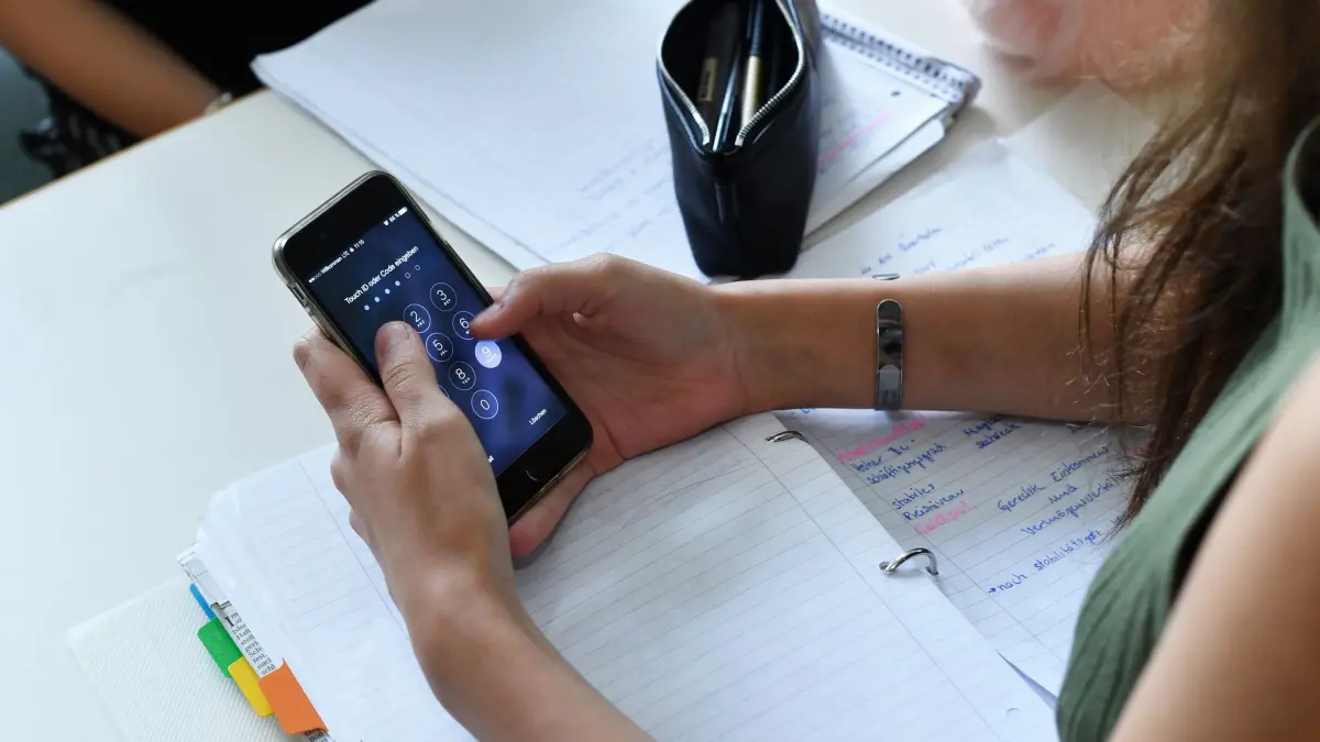 Eine Schülerin am Smartphone: ARCHIV - 22.06.2017, Berlin: Eine Schülerin hält im Unterricht ein Handy in den Händen. Die Schulleitungen in Niedersachsen dringen auf ein flächendeckendes Handyverbot an den Schulen. (zu dpa: «Schulleitungen dringen auf Handyverbot») Foto: Jens Kalaene/dpa-Zentralbild/dpa +++ dpa-Bildfunk +++