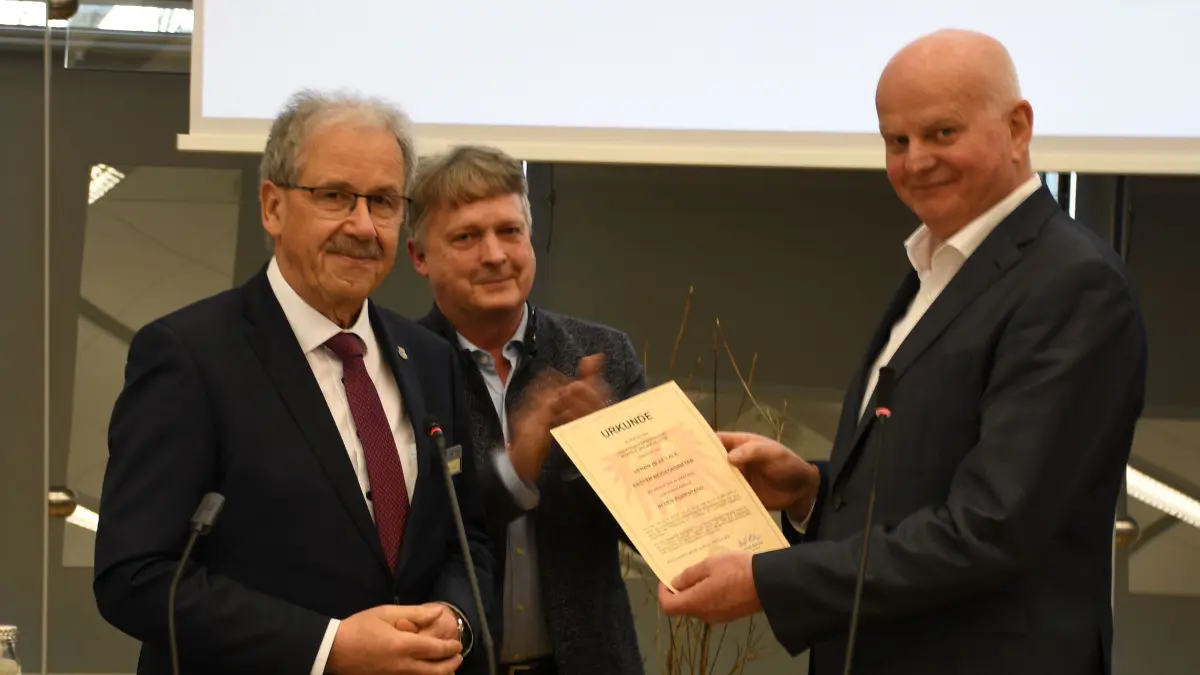 Olaf Lalk (r.) nimmt seine Entlassungsurkunde als Vize-Landrat und Dezernent des Superministeriums von Spree-Neiße entgegen. Landrat Harald Altekrüger (l.) und Kreistagsvorsitzender Torsten Schüler haben ihm für seine unaufgeregte Arbeit und Loyalität gedankt.