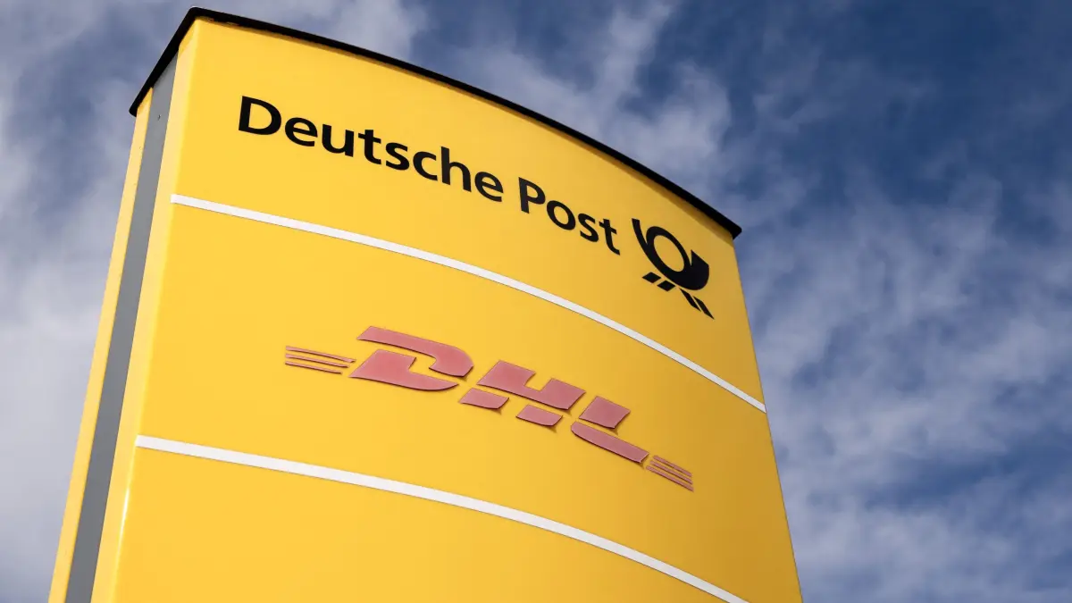 (FILES) A logo of German postal service Deutsche Post and DHL is seen at a logistics center in Dortmund, western Germany, on March 6, 2025. Medicines can stop pain, fight cancer and save lives but are worthless if they get lost in the mail, spoil in a hot warehouse or are stuck on a ship. This is where pharmaceutical logistics comes in -- a fast-growing sector in a world where key supply chains have been shaken by war, pandemic and trade chaos.One of its European hubs is what Germany's DHL calls its health logistics campus near Frankfurt, dedicated to ensuring drugs and other crucial medical products reliably get to where they're needed. (Photo by Ina FASSBENDER / AFP)