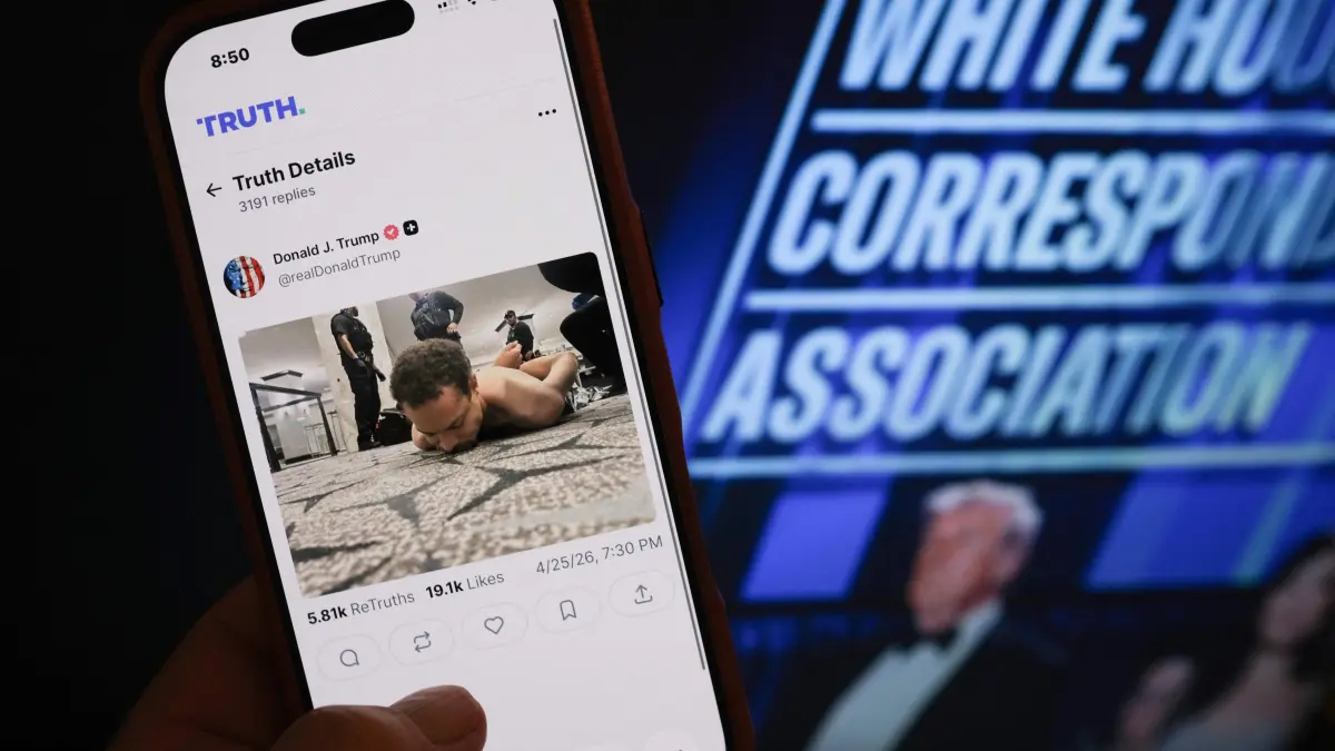 White House Correspondents' Association Dinner: This illustration photo taken in Los Angeles shows a phone with a Truth Social post by US President Donald Trump displaying an image of the alleged suspect in a shooting incident at the White House Correspondents’ Dinner on the ground after being apprehended on April 25, 2026. US Secret Service agents bundled Donald Trump from the stage as shots rang out Saturday evening at a media gala, in what the president later described as an attack by a "would-be assassin." Armed guards opened fire at the gunman who charged through security screening just outside the ballroom of the hotel, where Trump, First Lady Melania Trump, many senior government officials and hundreds of other black-tie guests had gathered. (Photo by Chris DELMAS / AFP)