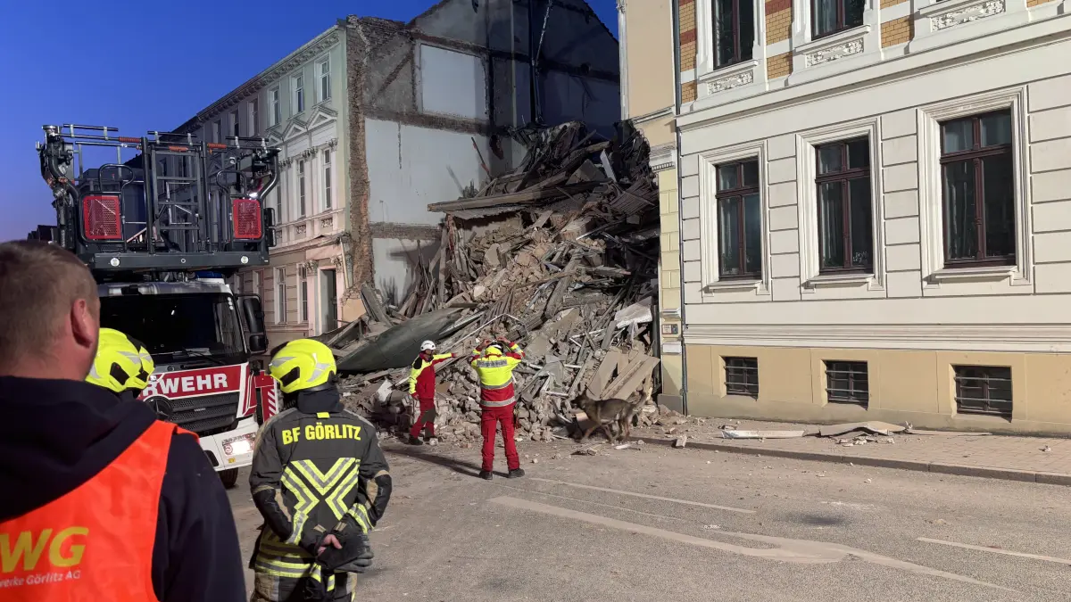 Einsturz eines Mehrfamilienhauses aus der Gründerzeit in der Görlitzer Innenstadt: Görlitz,James-von-Moltke-Straße. Wohnhaus eingestürzt. Vorausgegangen war offenbar eine Explosion. Feuerwehr und Rettungsdienst sind vor Ort. Der Bereich der James-von-Moltke-Straße ist weiträumig abgesperrt. Görlitz, 18.05.2026. Einsatzkräfte von Polizei und Feuerwehr stehen in der Nähe eines eingestürzten Hauses. Aus bislang ungeklärter Ursache ist in Görlitz ein Mehrfamilienhaus aus der Gründerzeit eingestürzt.