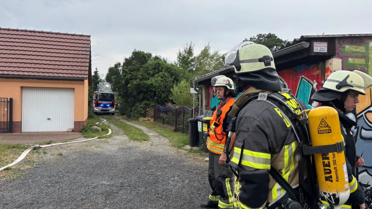 Bei dem Feuerwehreinsatz auf einem Privatgrundstück sind zwei Feuerwehrleute leicht verletzt worden. Sie erlitten leichte Rauchgasvergiftungen. Deswegen tragen Einsatzkräfte leichte Atemschutzmasken (rechts im Bild mit Sauerstoffflasche auf dem Rücken)