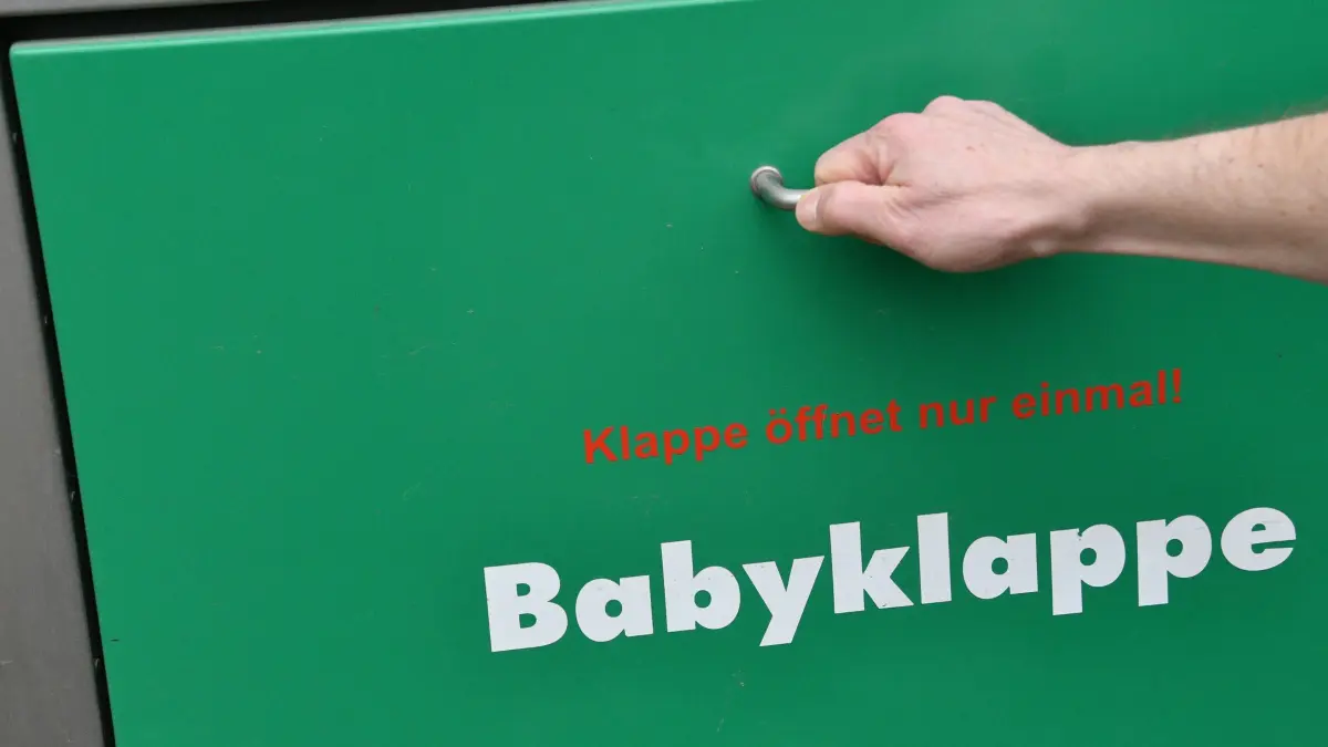 Babyklappe: ARCHIV - 10.02.2022, Brandenburg, Potsdam: Eine Hand greift nach der erneuerten Babyklappe am St. Josefs-Krankenhaus. (zu dpa: «Debatte um Babyklappe in Potsdam nach Aus für Geburtshilfe») Foto: Bernd Settnik/dpa-Zentralbild/dpa +++ dpa-Bildfunk +++