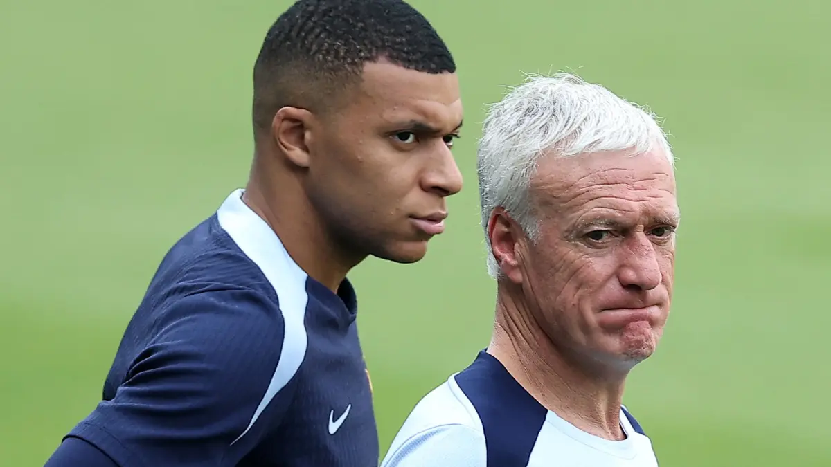 FILES-FBL-FRA-DESCHAMPS: (FILES) France's head coach Didier Deschamps (R) and France's forward #10 Kylian Mbappe (L) look on during a training session at the Home Deluxe Arena Stadium in Paderborn, western Germany, on June 27, 2024, during the UEFA EURO 2024 football competition. (Photo by FRANCK FIFE / AFP)