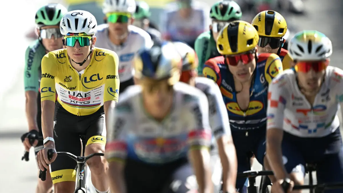 CYCLING-TDF-2026-STAGE 18: UAE Team Emirates - XRG's Slovenian rider Tadej Pogacar wearing the overall leader's yellow jersey cycles with the pack of riders (peloton) past the finish line of the 18th stage of the 113th edition of the Tour de France cycling race, 185,2 km between Voiron and Orcières-Merlette in the French Alps, on July 23, 2026. (Photo by Loic VENANCE / AFP)