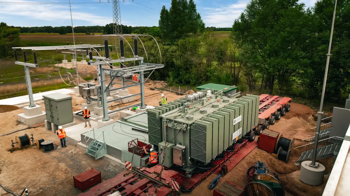 In Lüchow haben Arbeiter den Trafo auf die Stahlwanne geschoben und montiert. Jetzt geht es um die zweite Innovation aus dem Unternehmen