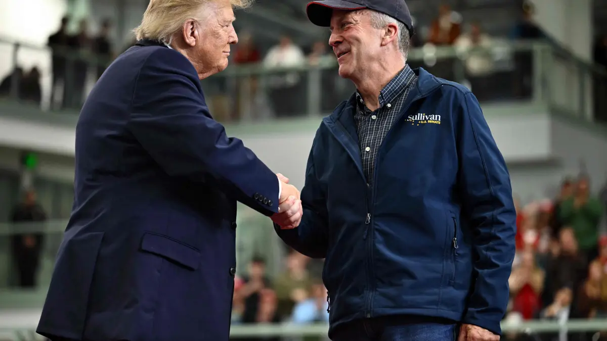 US-POLITICS-TRUMP: US President Donald Trump shakes hands with US Senator Dan Sullivan (R-AK) during a campaign rally at Curtis D. Menard Memorial Sports Center in Wasilla, Alaska, on October 13, 2026. (Photo by Kent NISHIMURA / AFP)