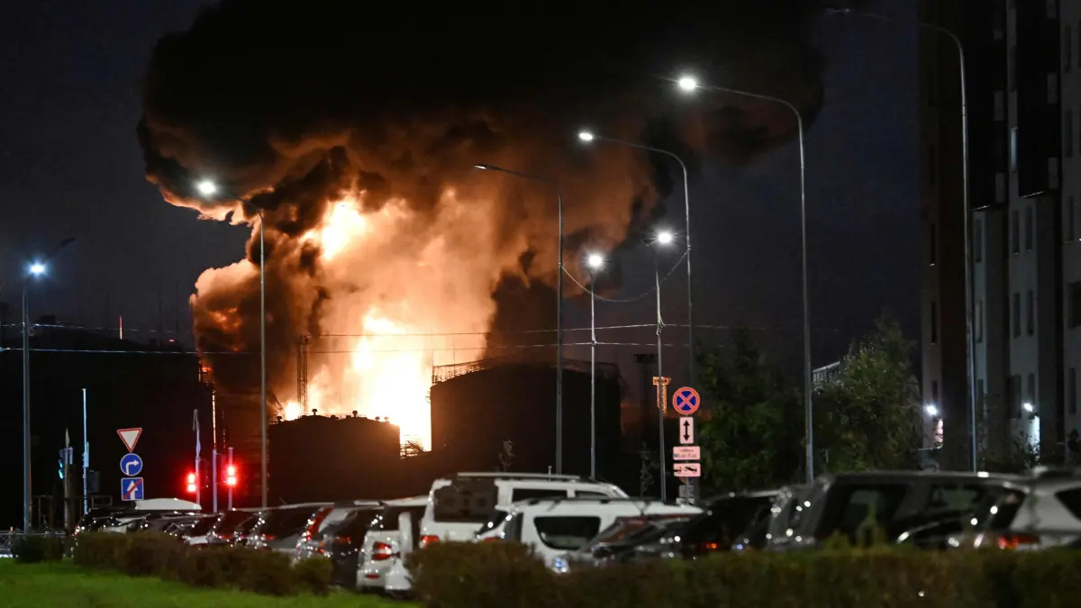 RUSSIA-UKRAINE-CONFLICT: This photograph taken on October 18, 2026 shows the burning oil terminal following an air attack in Saint Petersburg, amid the ongoing Russian-Ukrainian conflict. Russia shot down dozens of Ukrainian drones near Saint Petersburg, authorities said on October 18, 2026, with an oil terminal hit and flights disrupted at one of the country's busiest airports. (Photo by AFP)