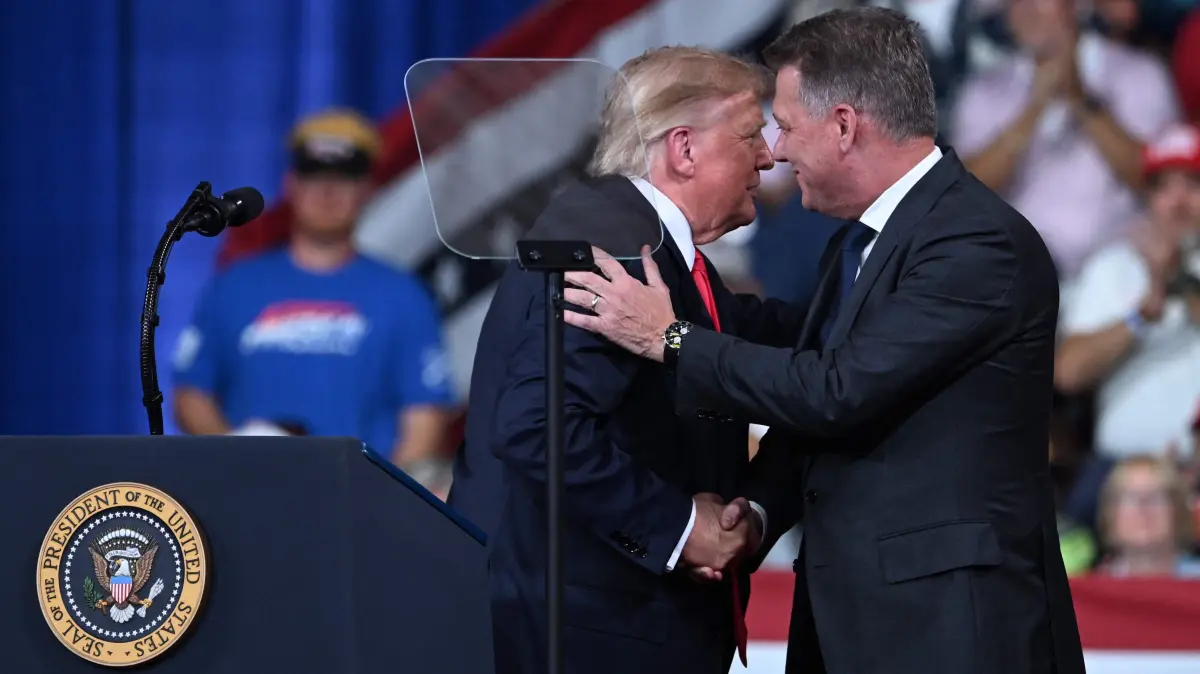 Donald Trump holds a rally in Perry, Georgia ahead of the midterms elections: US President Donald Trump greets CEO of Audi AG Gernot Dollner at a midterm election campaign rally at Guardian Centers of Georgia in Perry, Georgia on October 24, 2026. President Trump is traveling around the country to try to give a boost to Republicans in tight midterm races. (Photo by Brendan SMIALOWSKI / AFP)